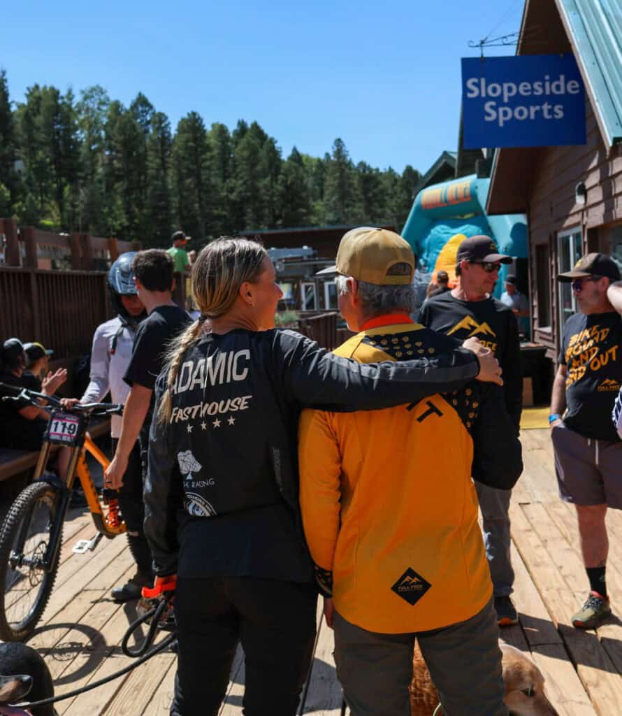 Mountain bikers chatting outside a bike shop in the pines