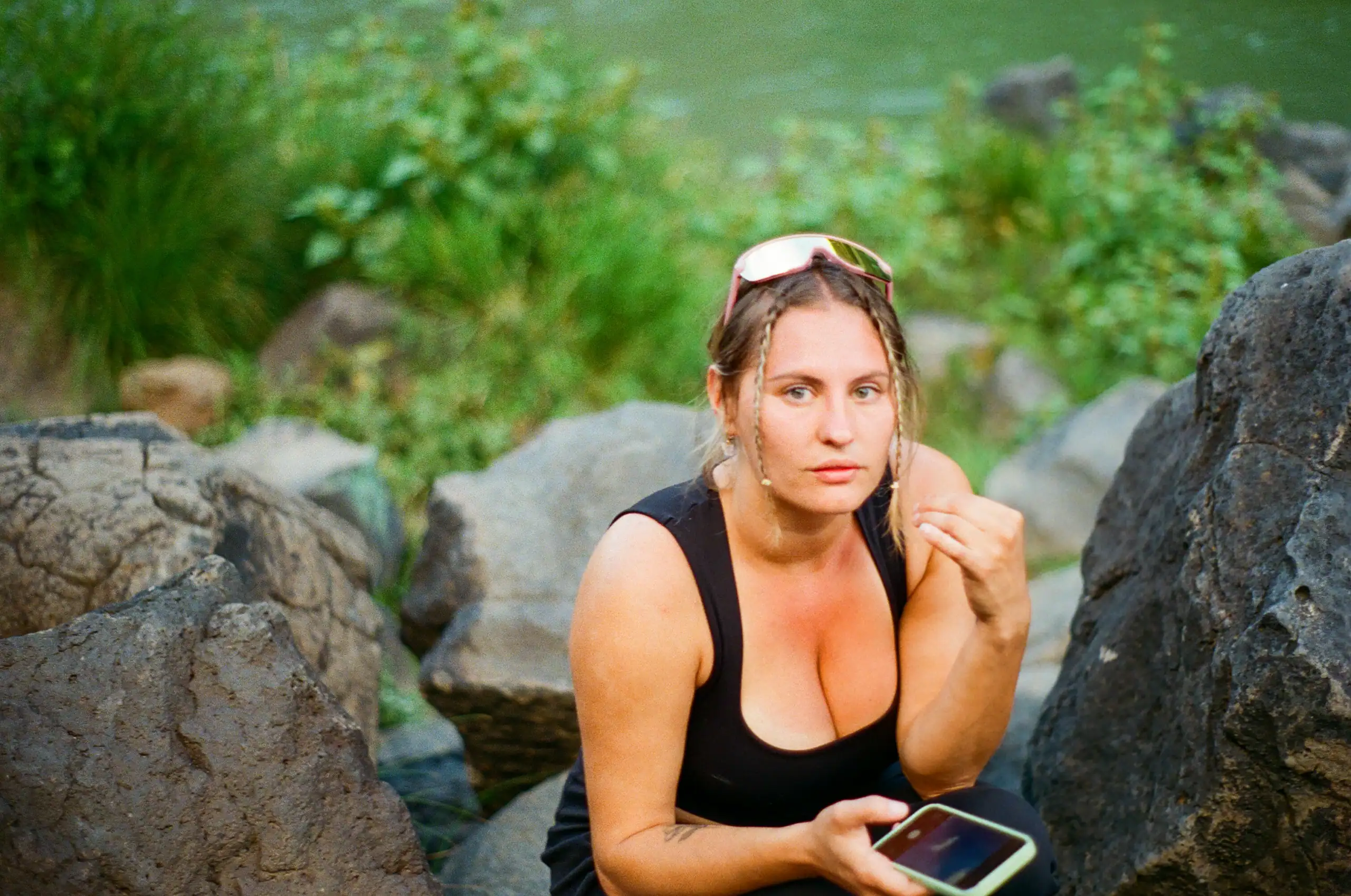 Portrait of a woman outdoors by rocks and greenery in Oklahoma.