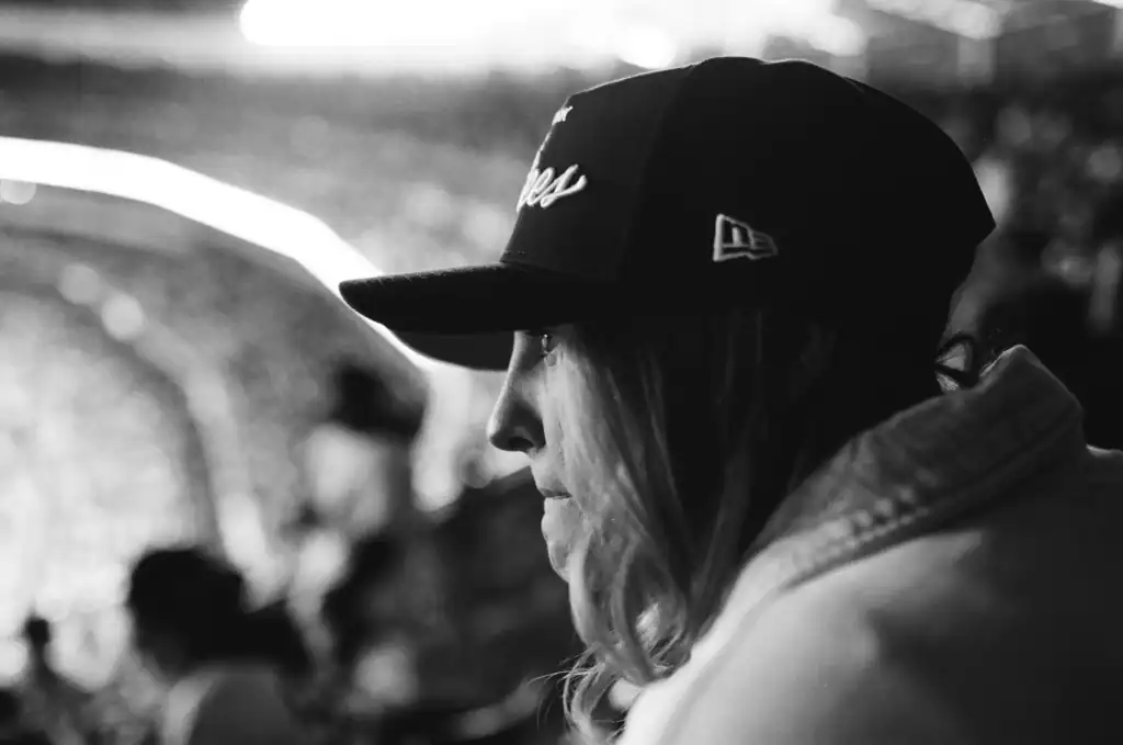 Portrait of a woman wearing a cap, side profile, black and white image.