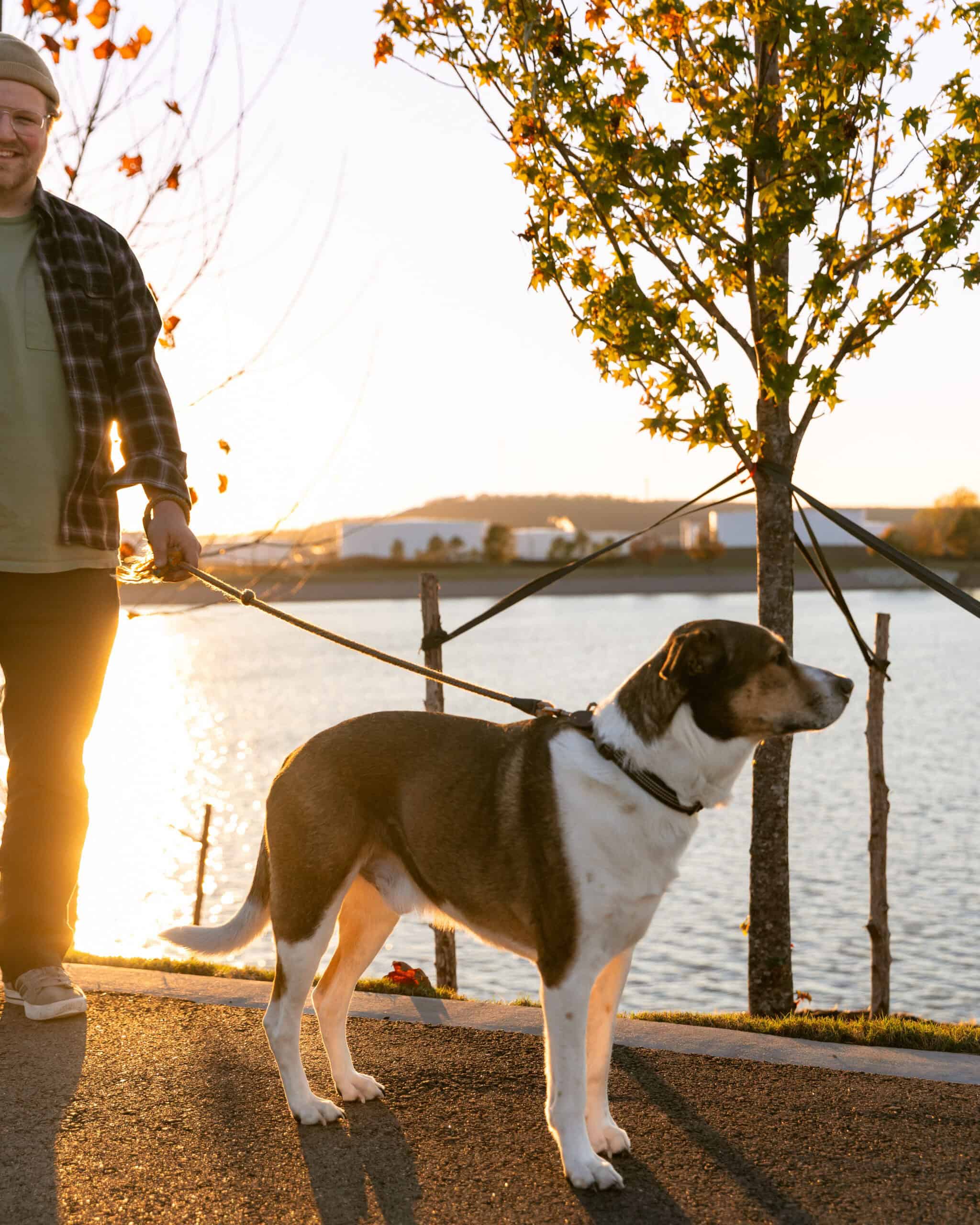 Portrait of a man and his dog by the lake during sunset in Oklahoma.