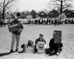 Protesters holding signs advocating for immigrant rights and opposing immigration laws in Oklahoma.