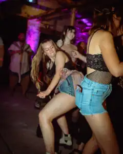 Young women dancing and having fun at a lively party in Oklahoma.