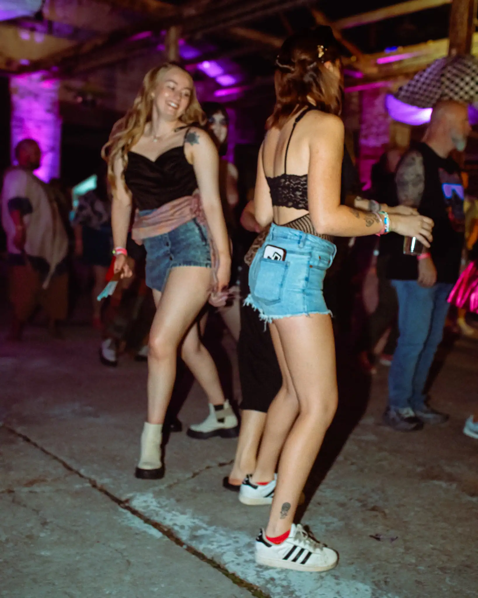 Group of young women dancing at a lively indoor event in Oklahoma.